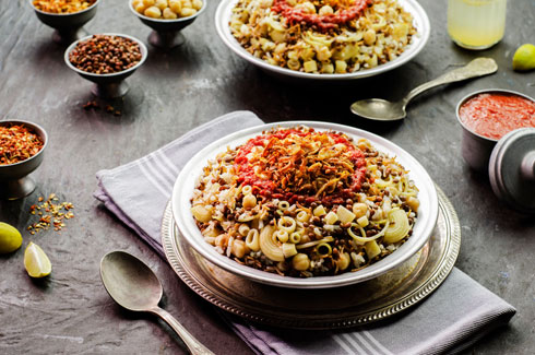 dishes of food on a table koshari Egyptian food